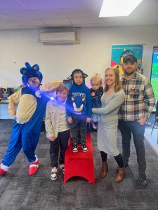 Sonic the Hedgehog with a family at a party
