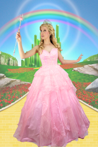 Picture showing a lady dressed as glinda the good with against a backdrop of the yellow brick road