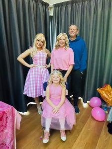 family pictured with a Barbie Entertainer
