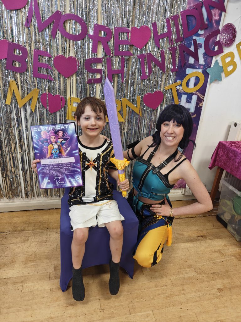 Entertainer dressed as Zoey from K Pop with a birthday child
