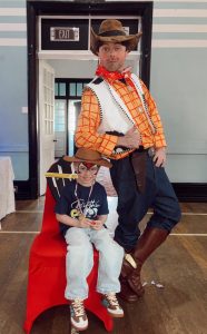 Picture showing child with an actor dressed as Woody from Toy Story