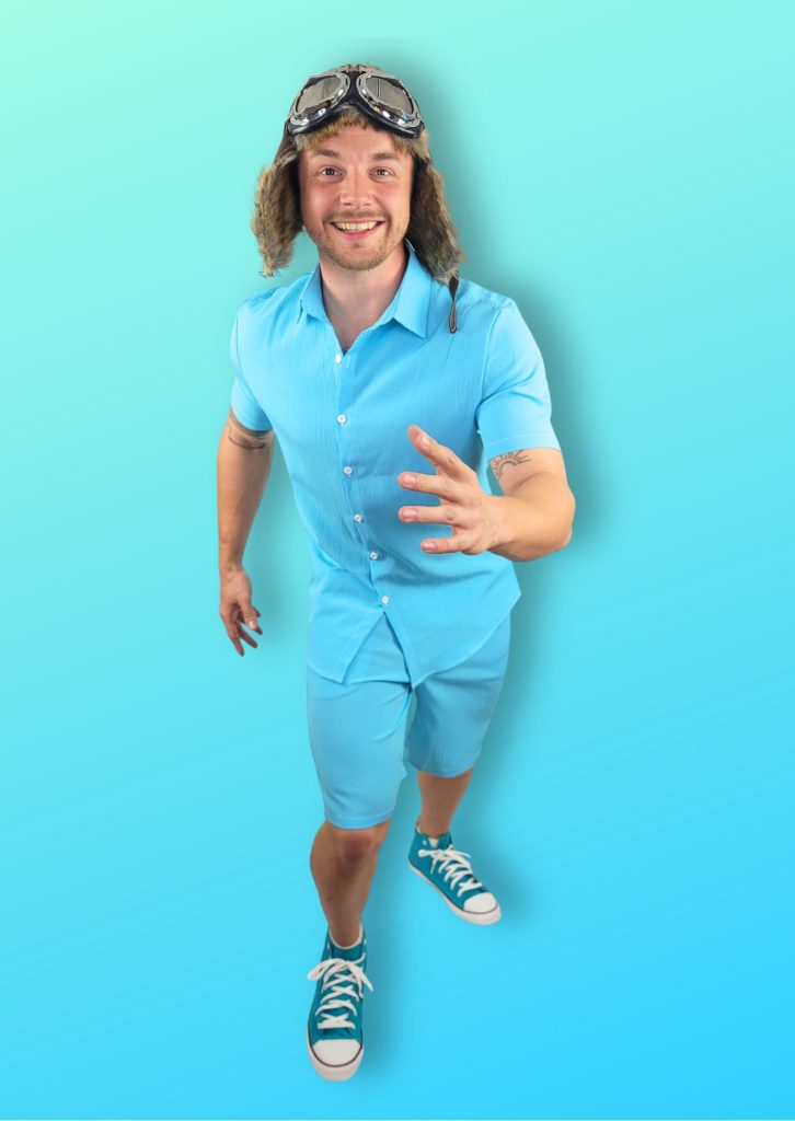 Entertainer dressed as Danny Go wearing blue shorts and shirt and pretending to run 