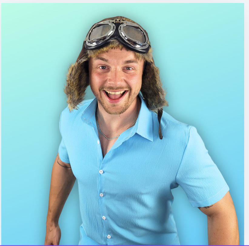 Entertainer dressed as Danny Go . Head and shoulders. He is wearing a blue shitrt and flying jacket