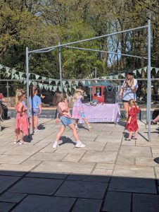 A Taylor Swift tribute entertains children in the sunshine at Garden King