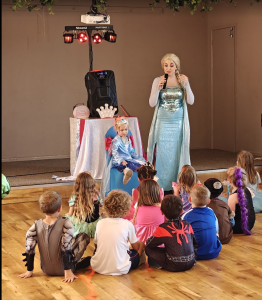 Actor performing at a party as Elsa